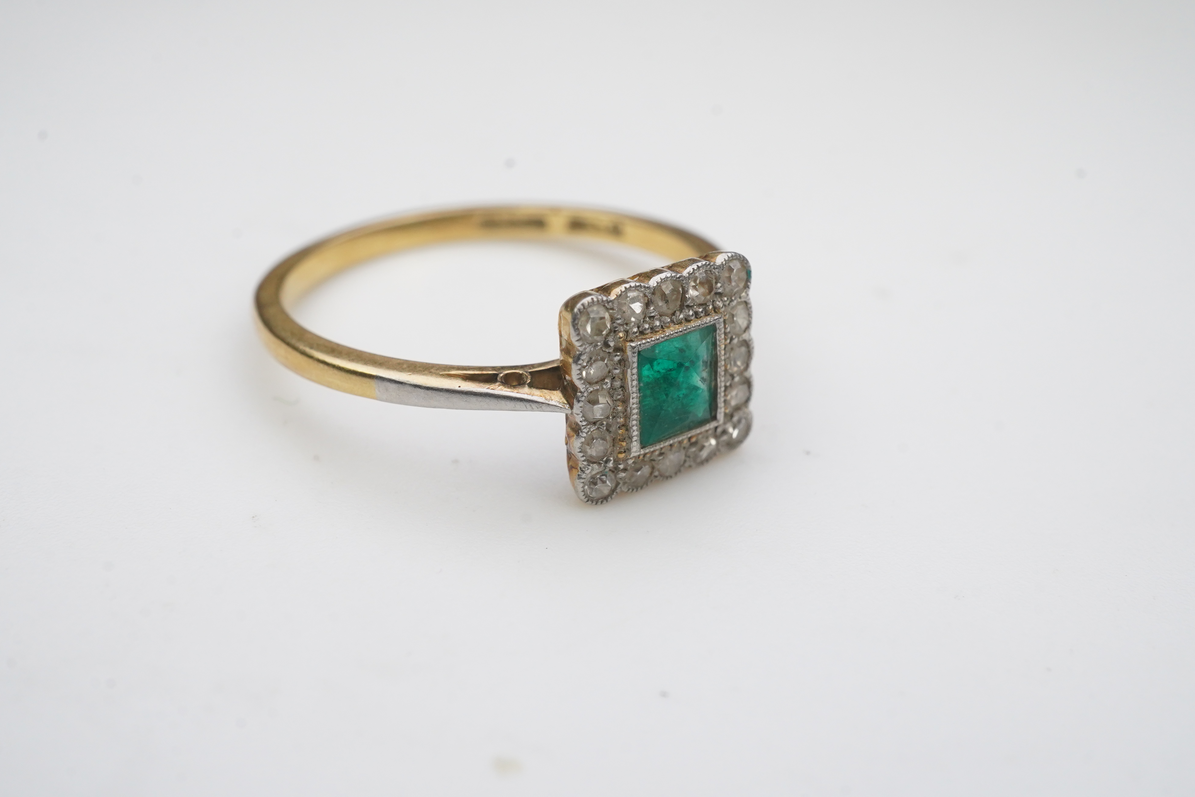 An emerald and diamond ring, early 20th century